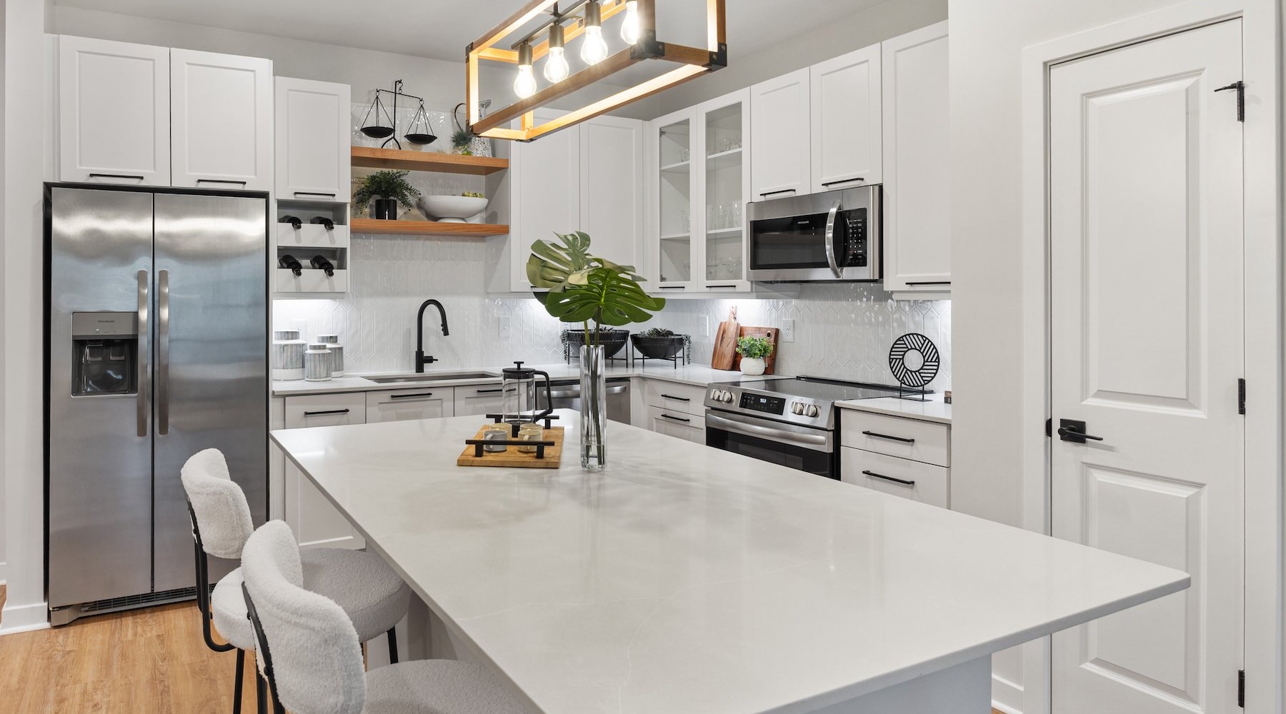 a kitchen with a large white island